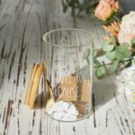 AW BRIDAL "I Love You Because" memory jar with a bamboo lid and 50 blank kraft paper love notes spilling out.