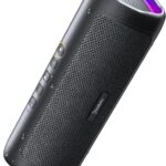 Black BolaButty portable Bluetooth speaker with colorful LED lights, shown outdoors on a picnic blanket.