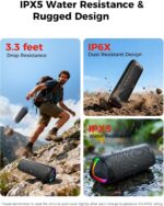 Black BolaButty portable Bluetooth speaker with colorful LED lights, shown outdoors on a picnic blanket.