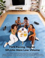 Black BolaButty portable Bluetooth speaker with colorful LED lights, shown outdoors on a picnic blanket.