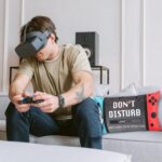 Rectangular red and black gamer throw pillow cover with a pair of red and white anti-skid gaming socks.