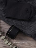 A grey and navy CASTATEO comfort care package featuring a knitted throw blanket, ceramic mug, and a small 'Positive Potato' t
