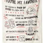 A beige Craftique "I Love You" flannel throw blanket, 60 by 50 inches, featuring romantic words and happy smile patterns.