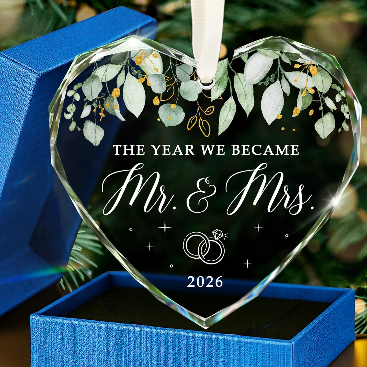 hexmoz-mr-mrs-2026-heart-glass-ornament-wedding-bridal-shower-gift-01 Heart-shaped glass ornament featuring "The Year We Became Mr & Mrs - 2026" in a navy blue gift box with an ivory ribbon.