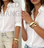 Three iF YOU chunky 14k gold plated bangle bracelets stacked on a woman's wrist, showing a radiant finish.