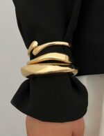 Three iF YOU chunky 14k gold plated bangle bracelets stacked on a woman's wrist, showing a radiant finish.