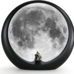 mamre Super Moon Lamp glowing softly, featuring a romantic couple silhouette under a full moon, with included decorative stic