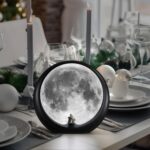 mamre Super Moon Lamp glowing softly, featuring a romantic couple silhouette under a full moon, with included decorative stic