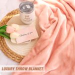 Suhctuptx pink birthday gift basket for women, including a flannel blanket, tumbler, candle, and bath bombs.