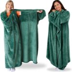 Adult wearing a Super Blanky Forest Green wearable blanket, lounging comfortably on a couch, showcasing its plush fabric and 
