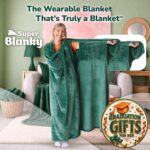 Adult wearing a Super Blanky Forest Green wearable blanket, lounging comfortably on a couch, showcasing its plush fabric and