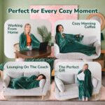 Adult wearing a Super Blanky Forest Green wearable blanket, lounging comfortably on a couch, showcasing its plush fabric and