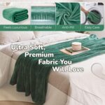 Adult wearing a Super Blanky Forest Green wearable blanket, lounging comfortably on a couch, showcasing its plush fabric and